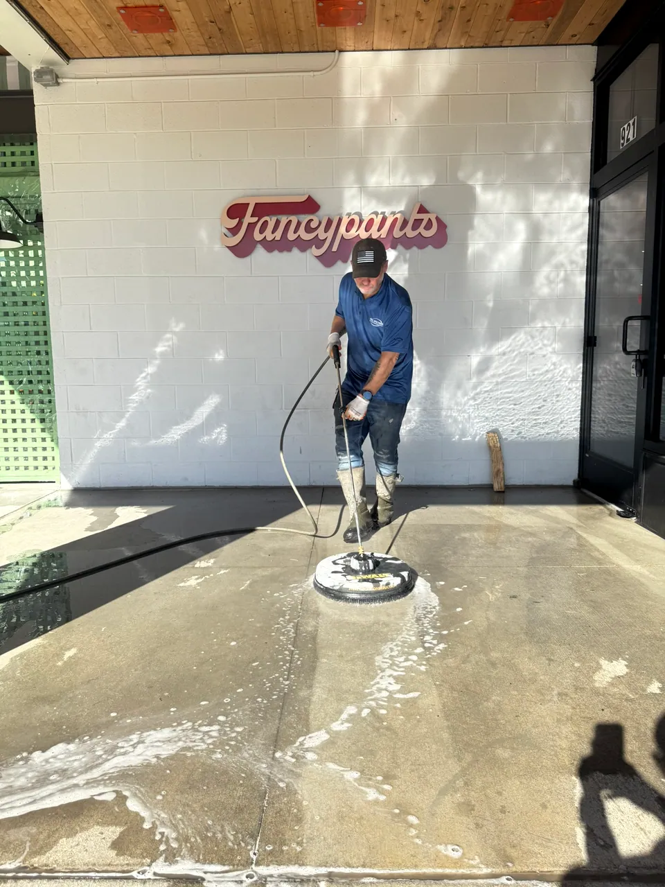 Operator using a surface cleaner outside the Fancypants storefront